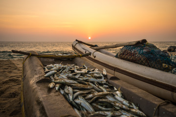 sunset behind fishing boat