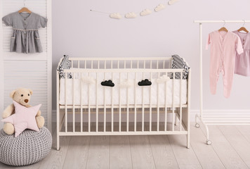 Stylish baby room interior with comfortable crib