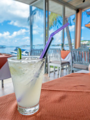 Ice lemondade in glass at seaside restaurant