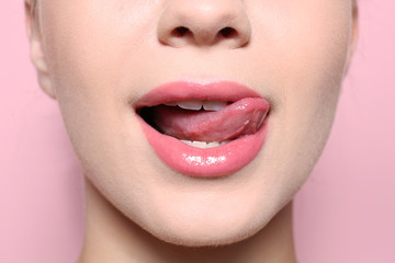 Beautiful young woman with perfect lips makeup on color background, closeup