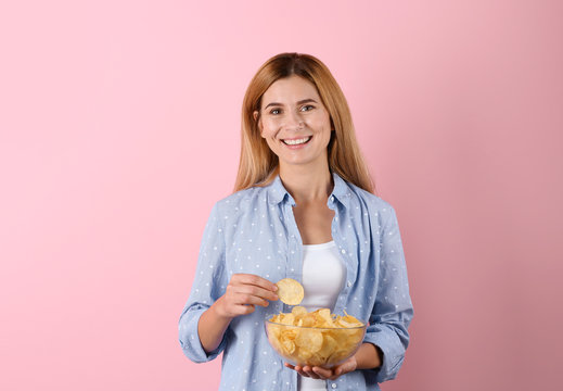 Woman With Bowl Of Potato Chips On Color Background