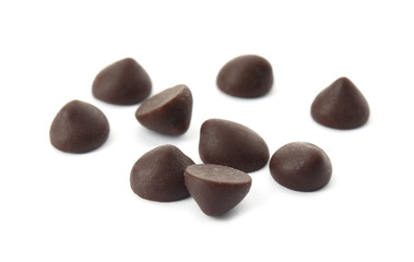 Pile of delicious dark chocolate chips on white background