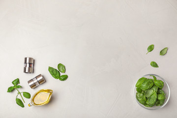 Flat lay composition with fresh basil leaves  on light background. Space for text