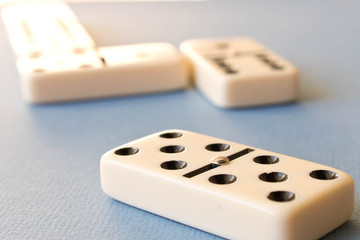 Playing dominoes on a blue background . Domino concept