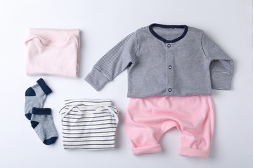 Flat lay composition with clothes for baby on white background