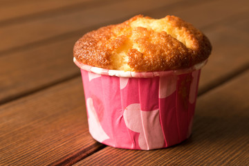Delicious fresh cupcake on wooden table. The concept of cooking with your hands