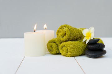 Obraz na płótnie Canvas Beauty spa background with burning candles and black massage stones