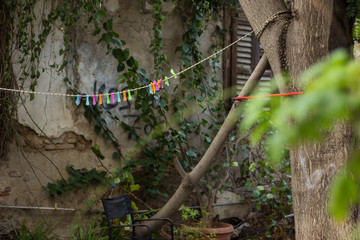 soft focus empty colorful pins for clothes hanging on string in poor slum back yard ghetto space environment