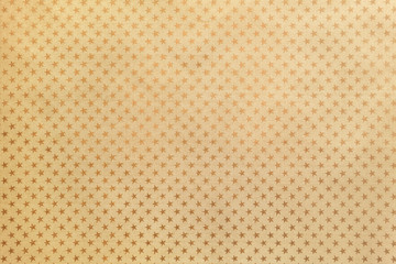 Golden background from metal foil paper with a stars pattern