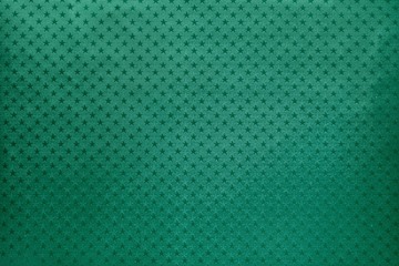 Green background from metal foil paper with a stars pattern