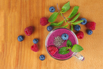 Glass of homemade blueberries smoothie with fresh mint and cia seeds