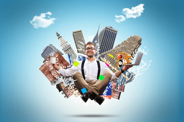 Young man is soaring in the air with a Cup of coffee and a laptop