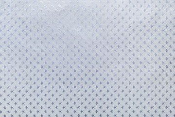 Silver background from metal foil paper with a stars pattern