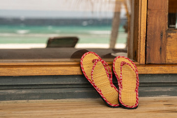 A pair flip flops on a porch at the Maldives