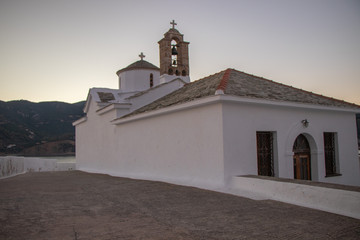 Fototapeta na wymiar Traditional Architecture of the Greek Islands - Sunrise at Christian Orthodox White Church at Skopelos, Northern Sporades - Panagitsa Tou Pirgou