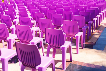 Naklejka premium Purple plastic chairs on the floor.