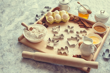 Delicious fresh and healthy ingredients for Christmas gingerbread. Placed on a wooden pastry board. View from above.