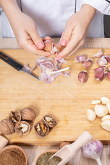 woman cook cleans garlic cloves