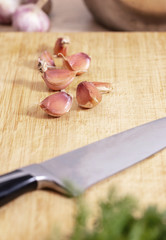 garlic cloves and a knife