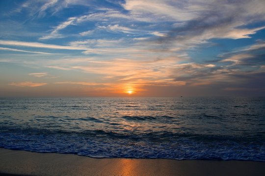 sunset on the beach with warm breezes and waves on the gulf coast