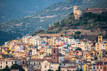Obraz premium The beautiful village of Bosa with colored houses and a medieval castle on the top of the hill. Bosa is located in the north-west of Sardinia, Italy.