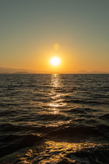 Fototapeta premium Golden sunset scenery over the horizon on the Mediterranean Sea in Greece - Aegean Sea ant the Northern Sporades - Skiathos, Alonissos