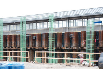 Obraz premium Workers are installing green welded wire steel mesh reinforcement for concrete construction