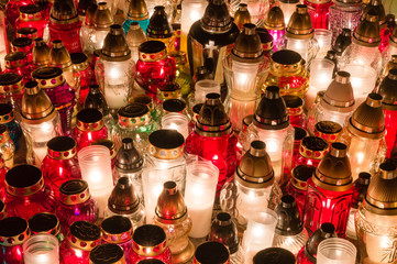 Lighting candles on the graves and tombs at polish cemetery at All Saints' Day.