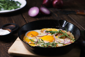 Healthy homemade cheap food, eggs and bacon in pan. Quick luncheon, home culinary