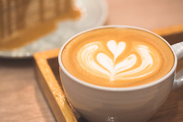 Close up latte coffee on the working table..