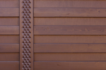 Wall or surface of wooden boards laid horizontally and covered with brown stain