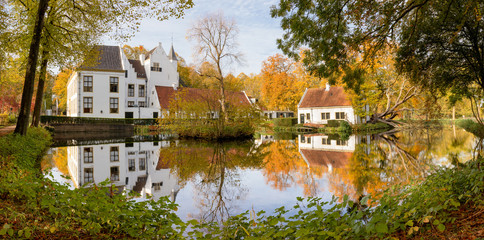 Fototapeta premium Panoramic view of the Rhoon castle in the Dutch town of Rhoon, South Holland, reflection, autumn colors