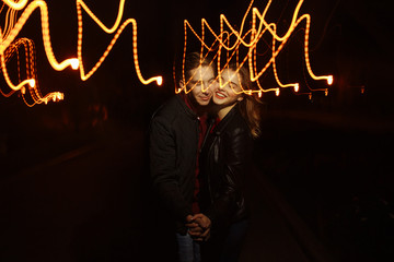 black background, couple dancing in the lights of light, dance of light, music of light,...