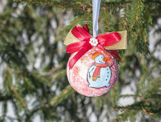 Christmas balls on a blurred natural background and falling snow