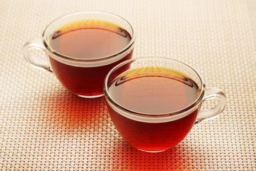 Two glass cups with black tea