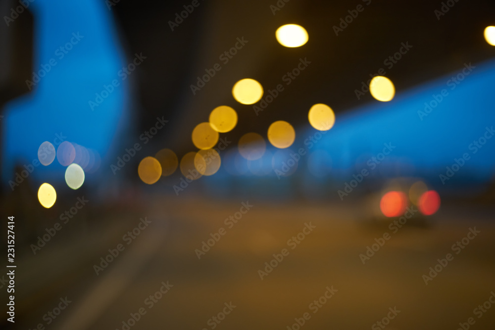 Poster blurred abstract background. defocused bokeh of evening road with lanterns