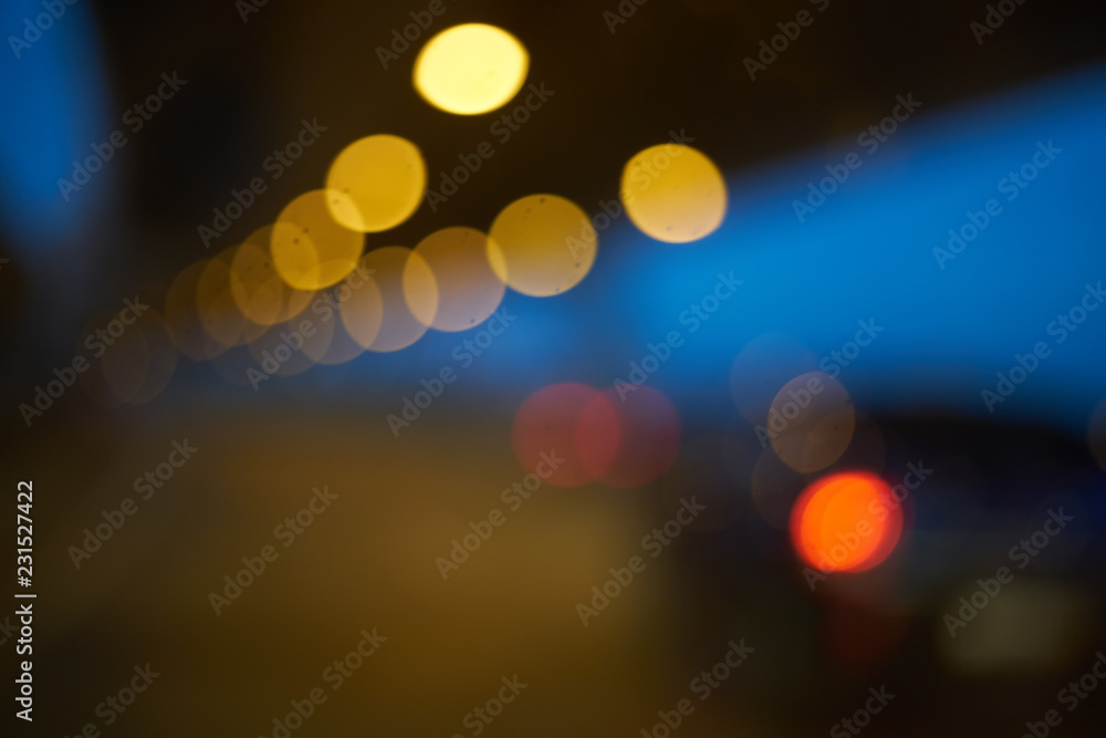 Poster blurred abstract background. defocused bokeh of evening road with lanterns