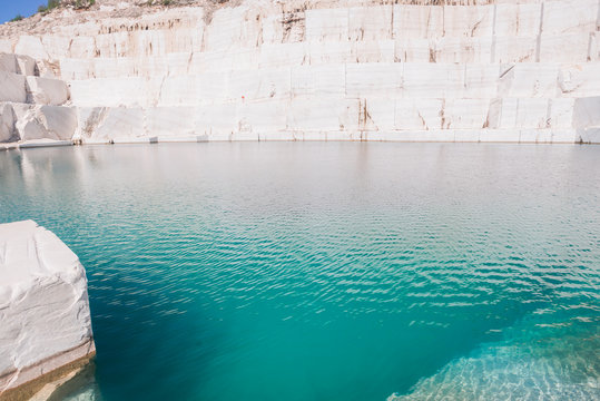 Marble Quarry Landscape In The Mountains With A Turquoise Lake Water