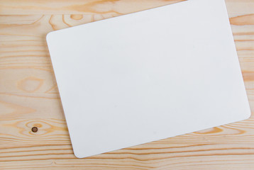 clean white sheet with rounded edges on a light-colored wooden background