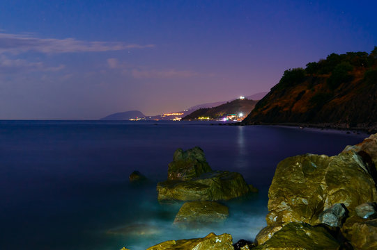 The night stones are washed by the surf. Long exposure