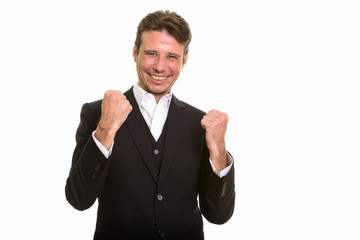 Happy Caucasian businessman looking motivated with arms raised