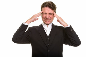 Stressed Caucasian businessman having headache with eyes closed