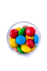 Multicoloured sweets in a little glass. Isolated object