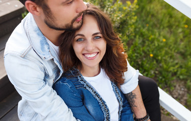 Fototapeta premium Embracing beautiful couple on stairway outdoors