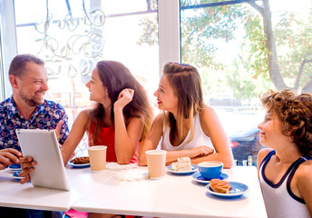 Children having fun in a cafe. Kids talking and drinking Coca for the breakfast in the city in the...