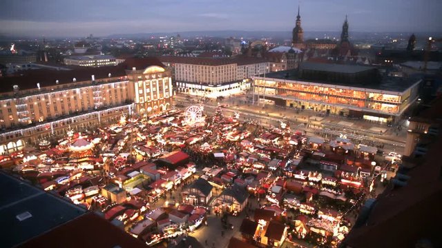 Dresden Christmas Market from above. View on Rolling Carousel attraction. City skyline. Night scenery. Christmas celebration in Europe, Germany.