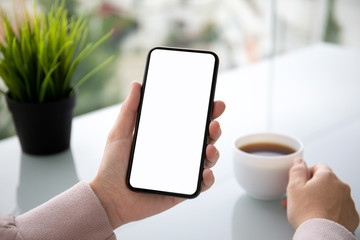 female hand holding touch phone with isolated screen in cafe