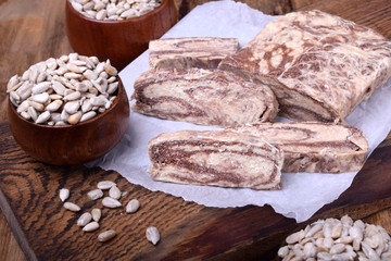 Halva with sesame seeds of two colours on a wooden board