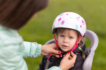 putting a bicycle helmet on a child