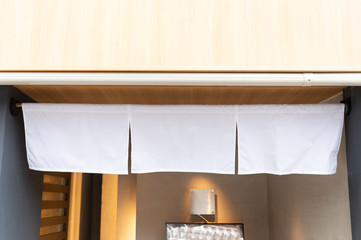 The curtain-like fabric that hangs in front of traditional Japanese restaurants and shops not only serves as a signboard, but holds a larger meaning,